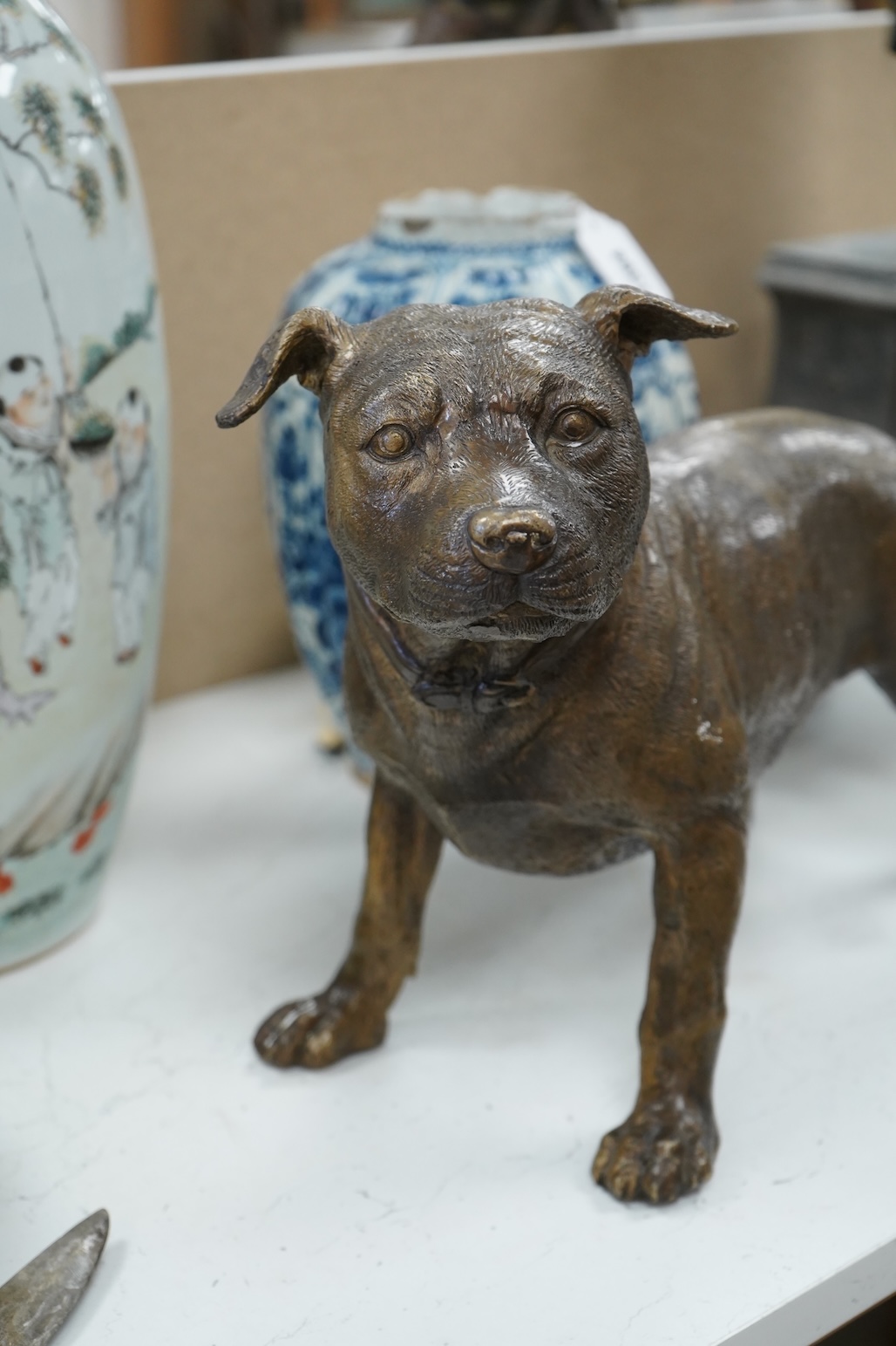 A large solid cast bronze model of a Staffordshire bull terrier, Italian, mid 20th century, signed, 45cm wide